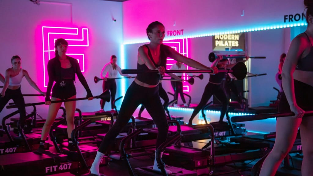 Girls are doing pilates in fit 407 reformer pilates studio