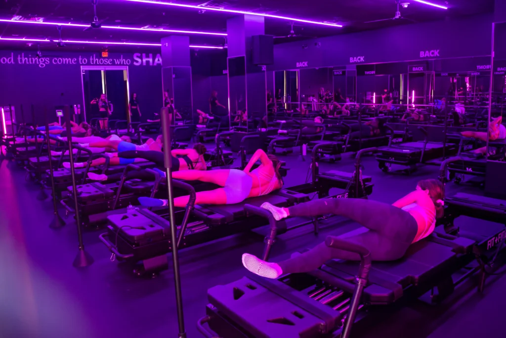 Women doing clamshells in Pilates Help to With Knee Pain and joint stiffness